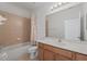 Bathroom featuring a shower-tub combo with tile surround and a vanity with a large mirror at 701 Fortanini Cir, Ocoee, FL 34761