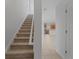 Carpeted stairs lead to the upper level of the home, adjacent to the kitchen and living areas at 701 Fortanini Cir, Ocoee, FL 34761