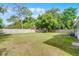 Large backyard with lush green grass and wood fence at 704 Baywood Dr, Sanford, FL 32773