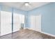 Light blue bedroom showcasing two closets, a ceiling fan, and a bathroom at 704 Baywood Dr, Sanford, FL 32773