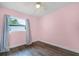 Cozy bedroom featuring pink walls and a window at 704 Baywood Dr, Sanford, FL 32773