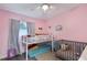 Pink themed bedroom with bunk bed and a crib at 704 Baywood Dr, Sanford, FL 32773