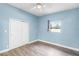 Cozy bedroom featuring light blue walls, a window, and closet at 704 Baywood Dr, Sanford, FL 32773