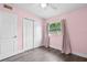 Pretty bedroom with pink walls and ample closet space at 704 Baywood Dr, Sanford, FL 32773