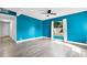 Bright bedroom with sleek flooring, a large window and striking blue accent wall at 704 Baywood Dr, Sanford, FL 32773
