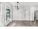 Dining area featuring wood floors, modern lighting, bright windows, and neutral decor at 704 Baywood Dr, Sanford, FL 32773