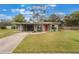 Charming single-story home with a well-maintained lawn and vibrant red front door at 704 Baywood Dr, Sanford, FL 32773