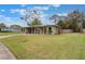 Inviting single-story home with lush front lawn and mature trees, creating curb appeal at 704 Baywood Dr, Sanford, FL 32773