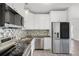 Modern kitchen featuring stainless steel appliances, granite countertops, and stylish backsplash at 704 Baywood Dr, Sanford, FL 32773