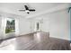 Open living room featuring sleek floors, ample natural light, and a modern ceiling fan at 704 Baywood Dr, Sanford, FL 32773