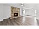 Spacious living room showcasing a striking stone fireplace and ample natural light at 704 Baywood Dr, Sanford, FL 32773