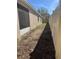 Narrow side yard with a fence on the right side, between the neighbor's property at 7314 Seena Ct, Orlando, FL 32835