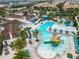 Aerial image displaying a large pool area, lazy river, and palm trees, providing a luxurious resort-style living experience at 8941 Rhodes St, Kissimmee, FL 34747