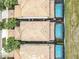 Aerial view of tiled roofs and screened-in pools in a residential neighborhood with lush landscaping at 8941 Rhodes St, Kissimmee, FL 34747