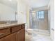 Bathroom features a granite countertop vanity and glass-enclosed shower at 8941 Rhodes St, Kissimmee, FL 34747