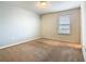 Bedroom featuring a neutral color palette, carpeting, and a bright window at 8941 Rhodes St, Kissimmee, FL 34747