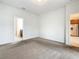 Neutral bedroom with adjacent bathroom and stainless steel refrigerator visible outside doorway at 8941 Rhodes St, Kissimmee, FL 34747