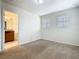 Bedroom featuring neutral walls, carpet flooring, and an ensuite bathroom at 8941 Rhodes St, Kissimmee, FL 34747