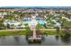 Aerial view of a stunning community pool and clubhouse featuring a lazy river, splash pad, and lake access at 8941 Rhodes St, Kissimmee, FL 34747