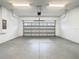 Spacious garage with a gray epoxy floor and a modern aluminum garage door at 8941 Rhodes St, Kissimmee, FL 34747