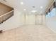 Bright, open living area with staircase, tile floors, neutral walls and recessed lighting at 8941 Rhodes St, Kissimmee, FL 34747