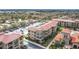 Beautiful aerial view of a sprawling condominium complex, lush landscaping, pool, and ample parking at 912 Charo Pkwy # 214, Davenport, FL 33897