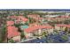 A beautiful aerial view of the condo community with pools, lush landscaping and ample parking at 912 Charo Pkwy # 214, Davenport, FL 33897