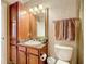 Bathroom with a granite-topped sink and lots of storage and a roll of paper at 912 Charo Pkwy # 214, Davenport, FL 33897