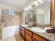 Bathroom featuring a bathtub, shower, and double vanity at 912 Charo Pkwy # 214, Davenport, FL 33897