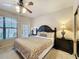 Bedroom featuring a ceiling fan, windows, and carpet at 912 Charo Pkwy # 214, Davenport, FL 33897