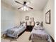 Bedroom with two twin beds with Mickey Mouse theme and a view of a ceiling fan at 912 Charo Pkwy # 214, Davenport, FL 33897