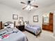 Bedroom with Mickey Mouse themed twin beds and ceiling fan with lights at 912 Charo Pkwy # 214, Davenport, FL 33897