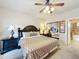 Comfortable bedroom features ceiling fan, mirrored closet, and an ensuite bathroom at 912 Charo Pkwy # 214, Davenport, FL 33897