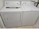 Efficient laundry room with a white side-by-side washer and dryer set at 930 Lake Doe Blvd, Apopka, FL 32703