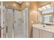 Bathroom showcasing glass shower, tiled walls, single sink vanity, and large mirror at 965 Rosinia Ct, Orlando, FL 32828