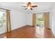 Bedroom featuring wood floors, neutral walls, and a sliding glass door leading to the backyard at 965 Rosinia Ct, Orlando, FL 32828