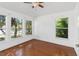 Sun-lit bedroom with hardwood floors and multiple windows that provide ample natural lighting at 965 Rosinia Ct, Orlando, FL 32828