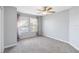 Bedroom showcasing two windows, plush carpet, neutral walls, and lilac curtains at 965 Rosinia Ct, Orlando, FL 32828