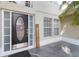 Close-up of the home's front door, complete with glass detailing and a welcome sign next to the entryway at 965 Rosinia Ct, Orlando, FL 32828