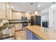 Well-lit kitchen with stainless steel appliances, tile floors, wooden cabinets, granite countertops, and a butcher block island at 965 Rosinia Ct, Orlando, FL 32828