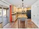 Well-lit kitchen with tile floors, wood cabinets, and a central island for prepping and cooking at 965 Rosinia Ct, Orlando, FL 32828