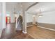 Spacious living room, accented by stylish wood flooring, and a staircase leading up to the second floor at 965 Rosinia Ct, Orlando, FL 32828