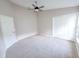 Bright bedroom with a double door closet, a white interior door, high ceilings, and carpeted floors at 1019 Royal Oaks Dr, Apopka, FL 32703