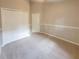 Bedroom with neutral walls, carpeted floors, a double door closet, and a white interior door at 1019 Royal Oaks Dr, Apopka, FL 32703