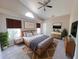 Bright bedroom with a large bed, plants, stylish furniture, and decor, creating a peaceful retreat at 1019 Royal Oaks Dr, Apopka, FL 32703