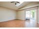 Open-concept living room with tile floors, skylight, and sliding glass door to the patio at 1019 Royal Oaks Dr, Apopka, FL 32703
