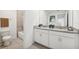 Bathroom with granite counter tops, double sinks, and a bathtub with tiled surround at 1136 Clay Blvd, Tavares, FL 32778