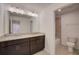 Bathroom featuring double vanity with granite countertop, dark cabinets and a bathtub with shower at 1136 Clay Blvd, Tavares, FL 32778