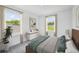 Bright bedroom with large windows overlooking the backyard and stylish decor at 1136 Clay Blvd, Tavares, FL 32778