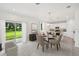 Dining Room features a modern chandelier, a glass dining table and sliding glass doors to the backyard at 1136 Clay Blvd, Tavares, FL 32778